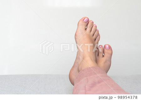 Closeup of female feet and toes on white background. Healthy feet concept Closeup of female feet and toes on white background. Healthy feet concept 98954378