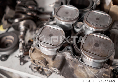Many tools and auto spare parts car at a car repair shop. Car parts for repairs. Used vehicle part for recycling in the scrap yard garage. Many tools and auto spare parts car at a car repair shop. Car parts for repairs. Used vehicle part for recycling in the scrap yard garage. 98954689