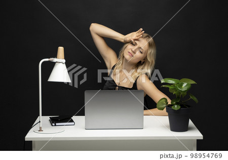 Frustrated unhappy laptop user woman touching head at work table with computer, going through stress, fatigue, burnout, getting bad news. Sad employee having problems with computer. 98954769