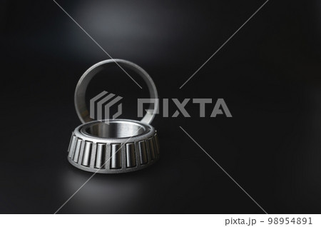 new two-piece roller bearing on a black background. Metal spare part for car suspension 98954891