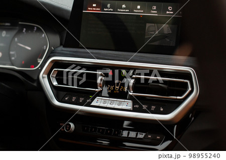 Color car air conditioning buttons close up view inside a car. Car temperature conditioner dashboard Color car air conditioning buttons close up view inside a car. Car temperature conditioner dashboard 98955240