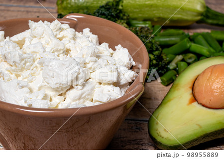 Cottage cheese and ripe avocado - proper nutrition and benefits for the body. Ingredients for keto diet, raw food diet, gluten free diet. 98955889