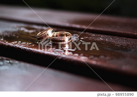 Gold rings with stones on a brown background Gold rings with stones on a brown background 98955890