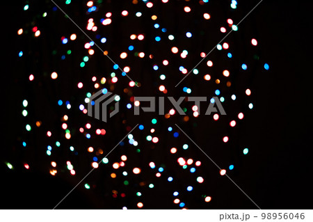 A brilliant glowing background side on black. The glitter light bokeh for the New Year and other holidays. Place for text copyspace. A brilliant glowing background side on black. The glitter light bokeh for the New Year and other holidays. Place for text copyspace. 98956046