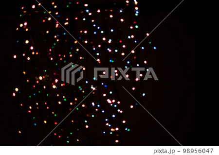 A brilliant glowing background side on black. The glitter light bokeh for the New Year and other holidays. Place for text copyspace. A brilliant glowing background side on black. The glitter light bokeh for the New Year and other holidays. Place for text copyspace. 98956047