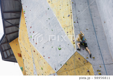 teen girl climbing up the wall 98956811