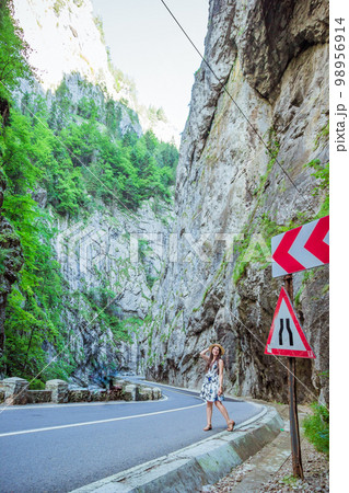 Woman in dress and straw hat in Bicaz Canyon 98956914