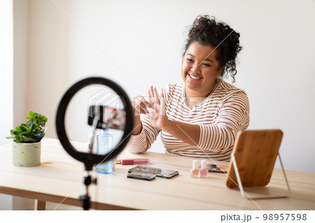 Positive friendly lady plus size streaming from home. Blogging concept 98957598