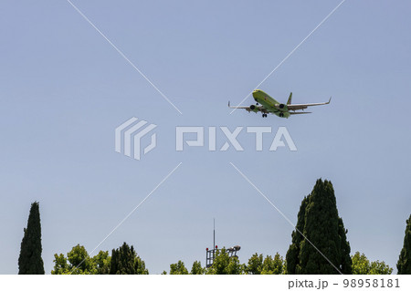 Passenger plane in the green coloring of the company S7 against the blue sky. Russia Sochi July 2022. Passenger plane in the green coloring of the company S7 against the blue sky. Russia Sochi July 2022. 98958181