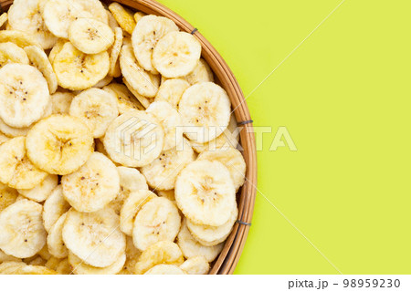 Banana slice chips on green background. Banana slice chips on green background. 98959230