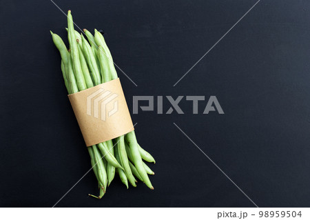 Green beans on dark background. 98959504