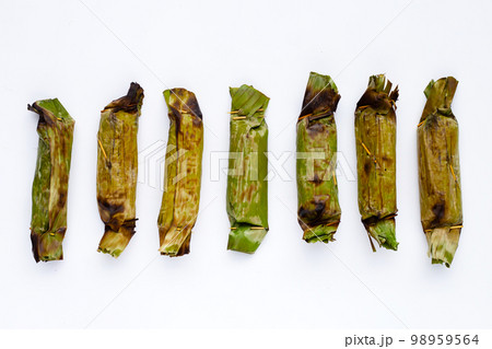 Grilled sticky rice in banana leaves with banana filling 98959564