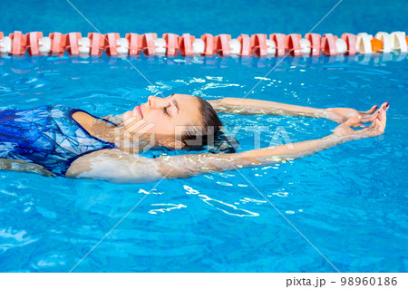 Young professional swimmer woman swimming in indoor pool  98960186