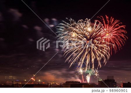 Colorful fireworks display over city. 98960901