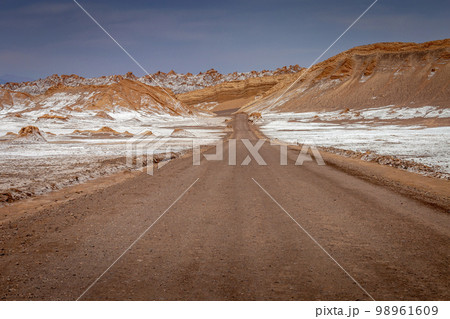 Dirt road in Moon Valley dramatic landscape at Sunset, Atacama Desert, Chile 98961609