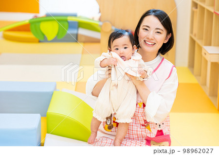 赤ちゃんを抱っこする保育士 赤ちゃんを抱っこする保育士 98962027