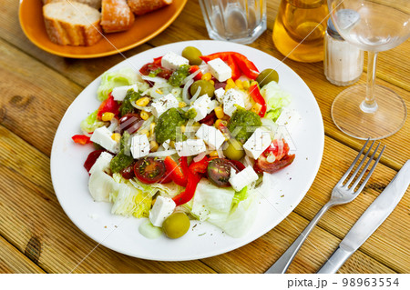 Portion of fresh salad served on table 98963554