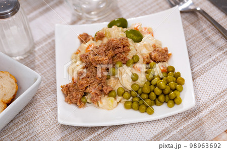 Spanish style Olivier salad with canned tuna, green peas and olives 98963692