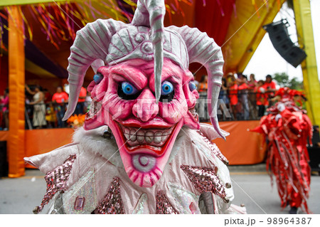 A man in a carnival costume and mask. A man in a carnival costume and mask. 98964387
