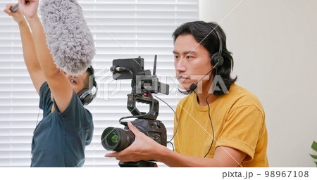 videographer filming video 98967108