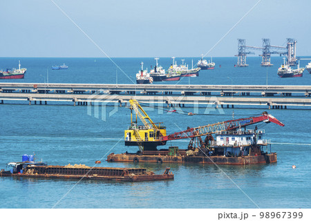 Engineering shipping crane depot at logistic export terminal control. Warehouse freight background container yard loading quayside harbor port. Logistics seascape shipping portal concept 98967399