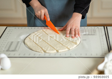 Using the kitchen silicone baking mat with markings and tips in the process of cooking in the kitchen with copy space 98968605