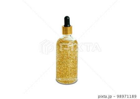 Serum collagen moisturizer of face into clear gold bottle soft light background. Protector skin Treatment facial essence oil, Vitamin C. Beauty and spa Concept 98971189