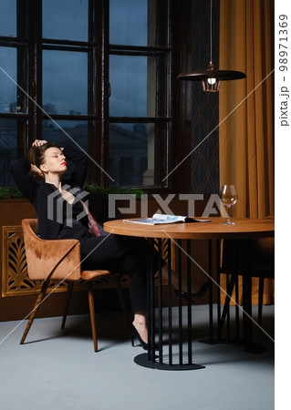 Satisfied woman read her article in magazine 98971369