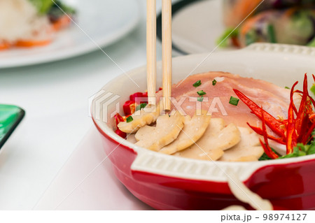 Close up of PHO with sliced pork soup with wooden chopsticks. Close up of PHO with sliced pork soup with wooden chopsticks. 98974127