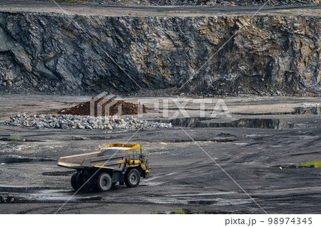 Dump truck in limestone mining, heavy machinery. Mining in the quarry. 98974345