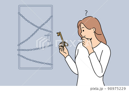 Woman with key stand near locked doors 98975229