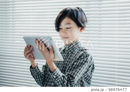 タブレットに夢中な男子 98976477