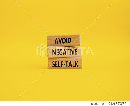 Avoid negative self-talk symbol. Concept words Avoid negative self-talk on wooden blocks. Beautiful yellow background. Business and Avoid negative self-talk concept. Copy space. 98977072