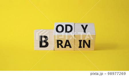 Body vs Brain symbol. Turned Wooden cubes with words Brain and Body. Beautiful yellow background. Business and Body vs Brain concept. Copy space. 98977269