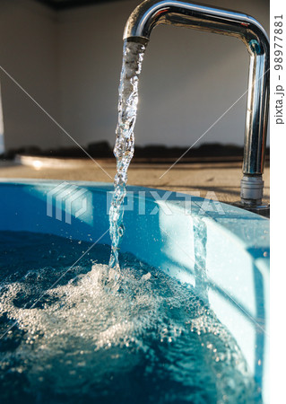 Little plunge pool with cold water preparing after relaxing in hot tube. Pool in field with water 98977881