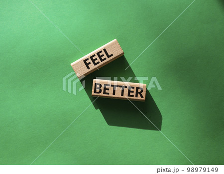Feel better symbol. Wooden blocks with words Feel better. Beautiful green background. Business and Feel better concept. Copy space. 98979149