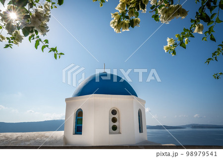 Famous blue dome of an orthodox church in Oia town Famous blue dome of an orthodox church in Oia town 98979541