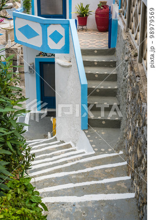 Steep and narrow alleys in Olymbos village Steep and narrow alleys in Olymbos village 98979569
