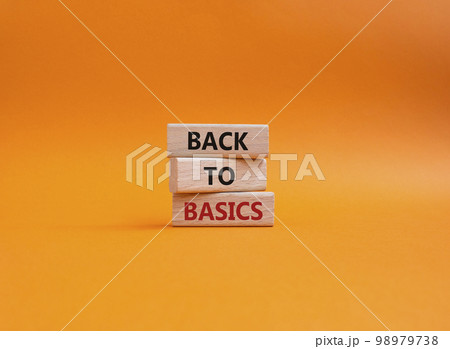 Back to basics symbol. Concept word Back to basics on wooden blocks. Beautiful orange background. Business and Back to basics concept. Copy space 98979738