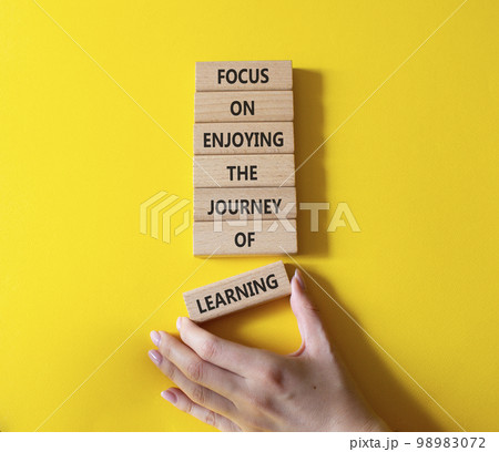 Learning symbol. Wooden blocks with words Focus on enjoying the journey of learning. Businessman hand. Beautiful yellow background. Business and Start and Learning concept. Copy space. Learning symbol. Wooden blocks with words Focus on enjoying the journey of learning. Businessman hand. Beautiful yellow background. Business and Start and Learning concept. Copy space. 98983072