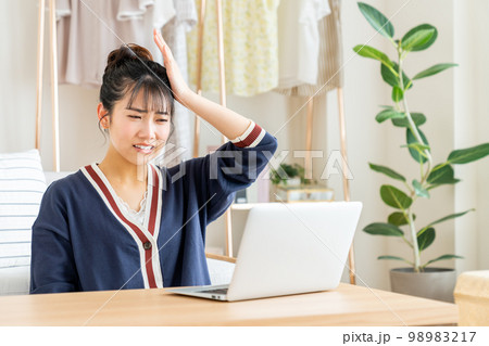 パソコンを見て驚く若い女性 パソコンを見て驚く若い女性 98983217