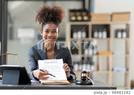 Woman lawyer working on a laptop. Legal law, advice and justice concept Woman lawyer working on a laptop. Legal law, advice and justice concept 98983282