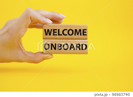 Welcome onboard symbol. Concept words Welcome onboard on wooden blocks. Beautiful yellow background. Businessman hand. Business and Welcome onboard concept. Copy space. Welcome onboard symbol. Concept words Welcome onboard on wooden blocks. Beautiful yellow background. Businessman hand. Business and Welcome onboard concept. Copy space. 98983740