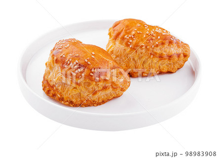 Puff pastry with sesame seeds on white plate 98983908