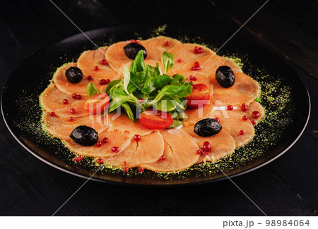 The tartare or carpaccio salmon salad 98984064