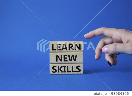 Learn new skills symbol. Concept words Learn new skills on wooden blocks. Beautiful blue background. Businessman hand. Business and Learn new skills concept. Copy space. Learn new skills symbol. Concept words Learn new skills on wooden blocks. Beautiful blue background. Businessman hand. Business and Learn new skills concept. Copy space. 98984506