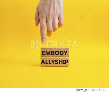 Embody Allyship symbol. Concept word Embody Allyship on wooden blocks. Beautiful blue background. Businessman hand. Business and Embody Allyship concept. Copy space Embody Allyship symbol. Concept word Embody Allyship on wooden blocks. Beautiful blue background. Businessman hand. Business and Embody Allyship concept. Copy space 98984659