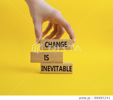 Change is Inevitable symbol. Wooden blocks with words Change is Inevitable. Beautiful yellow background. Businessman hand. Business and Change is Inevitable concept. Copy space. 98985241