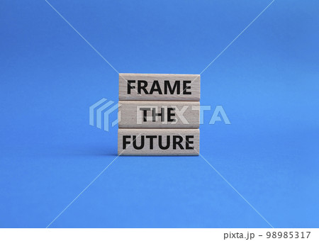 Frame the future symbol. Wooden blocks with words Frame the future. Beautiful blue background. Business and Frame the future concept. Copy space. 98985317