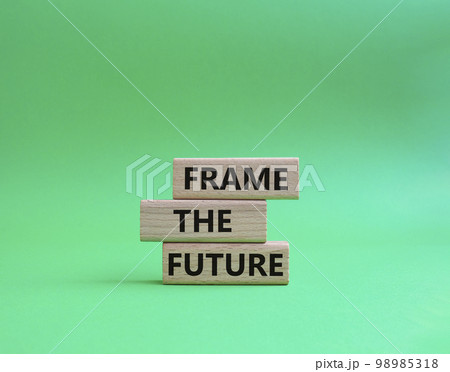 Frame the future symbol. Wooden blocks with words Frame the future. Beautiful green background. Business and Frame the future concept. Copy space. 98985318